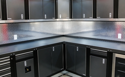 black and gray steel cabinets with angled corner shelf in uppers and perfectly mitered corner in lowers