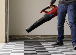 man cleaning Swisstrax grey and black Ribtrax Pro flooring