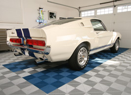 white and blue Mustang on silver and blue Swisstrax Ribtrax Pro flooring