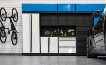 a wall of gray steel cabinets customized to the garage owner's storage needs